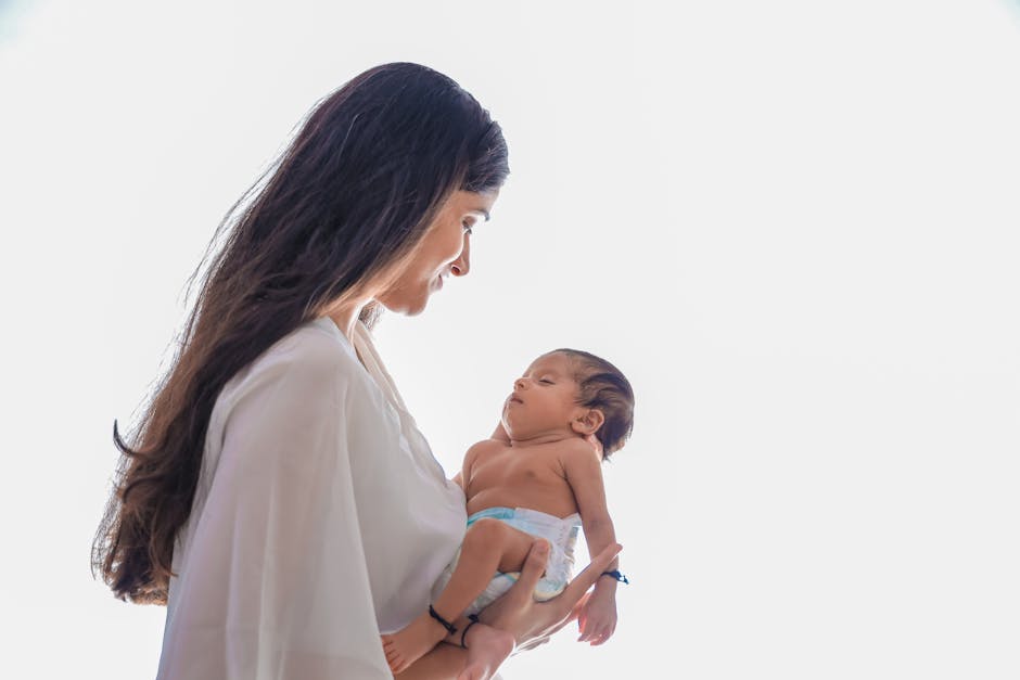 A tender moment showcasing a mother holding her newborn baby with affection and care.
